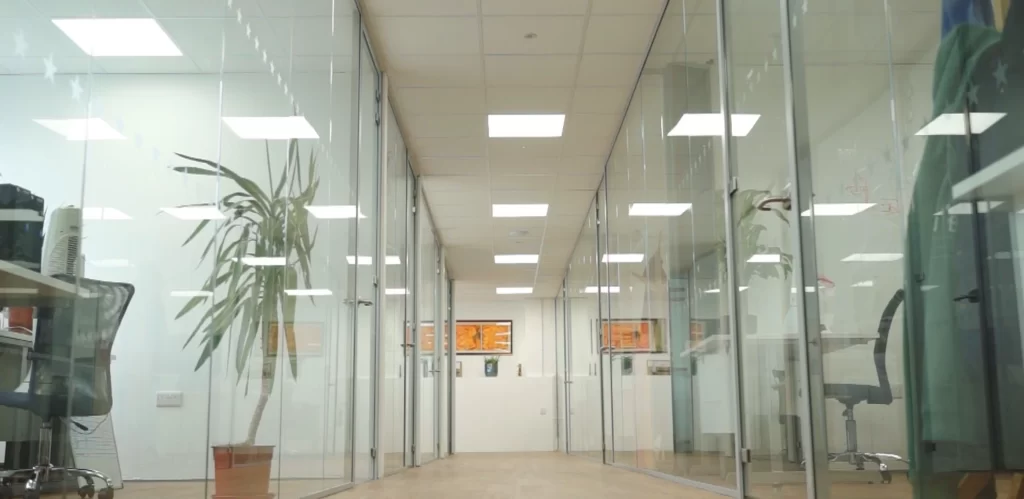 Laptop on desk in hybrid home working setup.