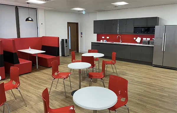 Benefits of Hybrid Working | Office break room with branded seating and bar.