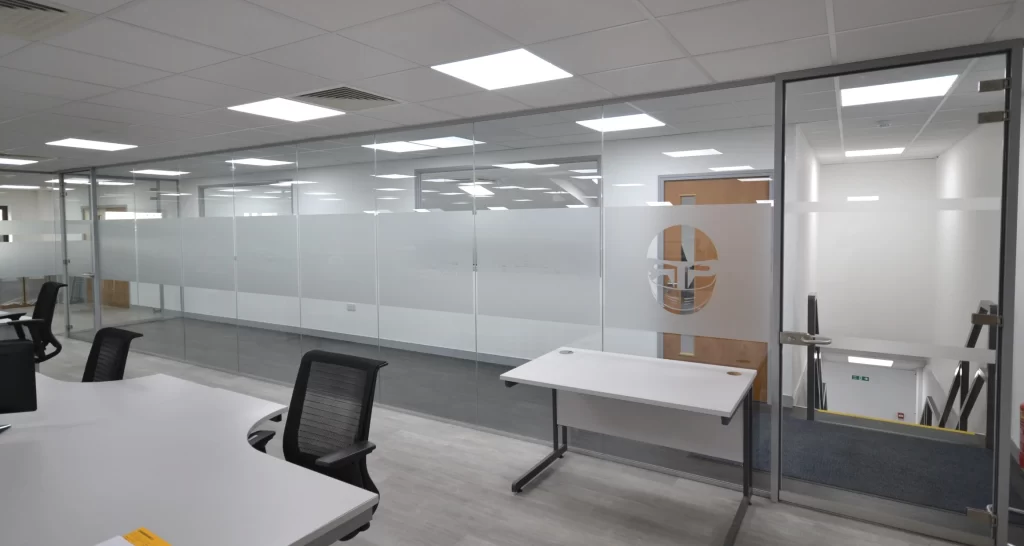 Glass wall partition | new office space with red sofa and glass wall partitions