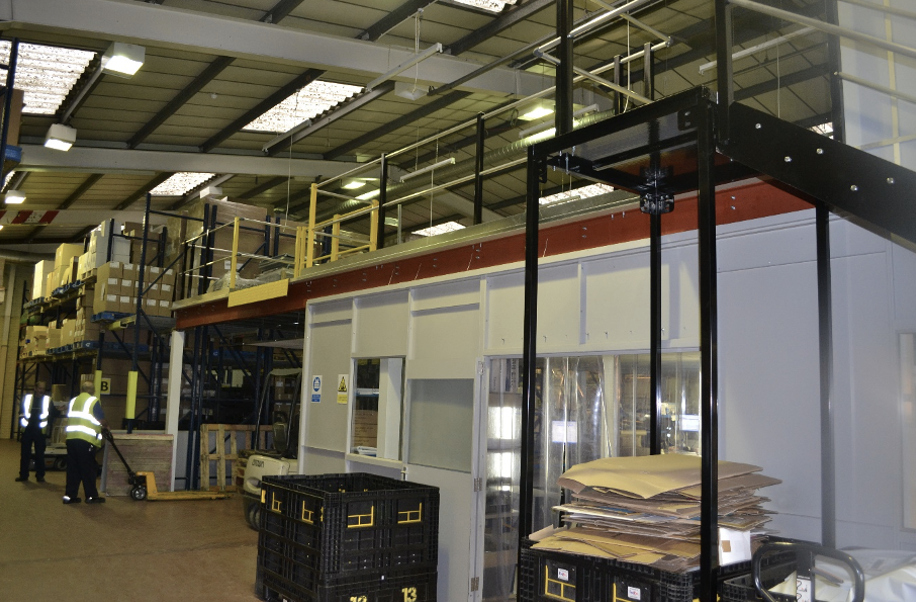 Mezzanine storage | A mezzanine storage floor with access stairs and yellow safety rails