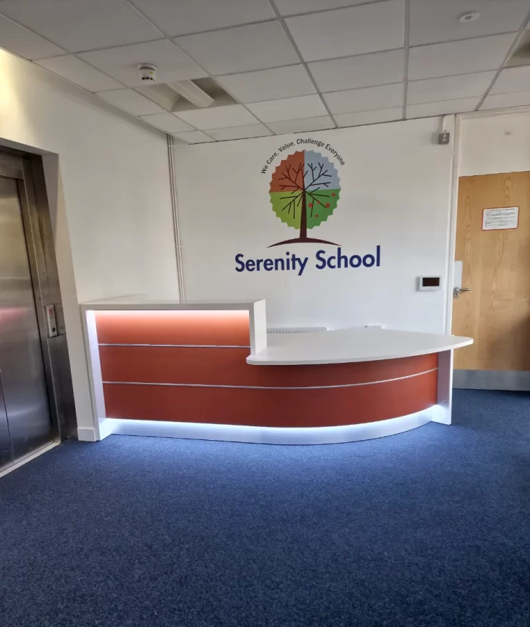 Serenity School - Reception area with logo on wall.