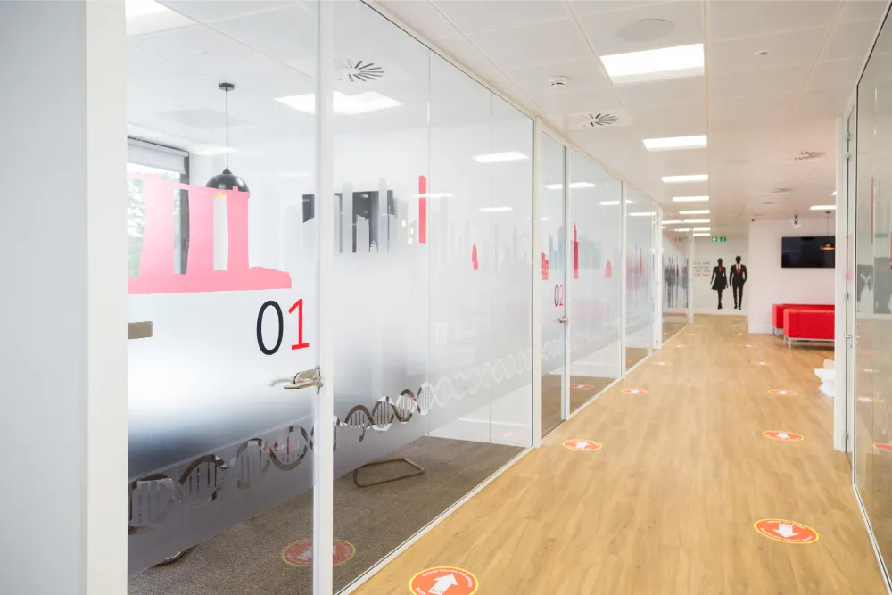 Barrington James - glass partitions along corridor