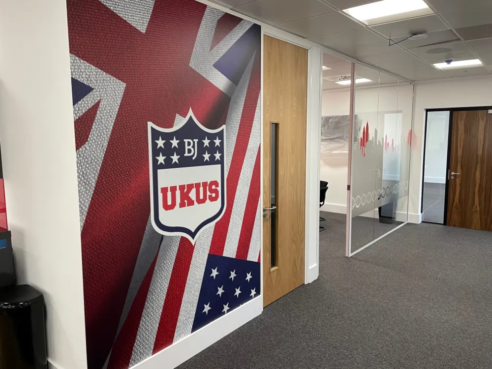 Barrington James - office corridor with company logo on walls