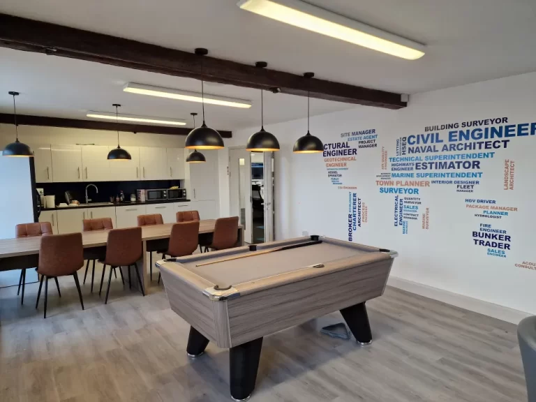 Consortio - Break room with pool table and dining chairs.