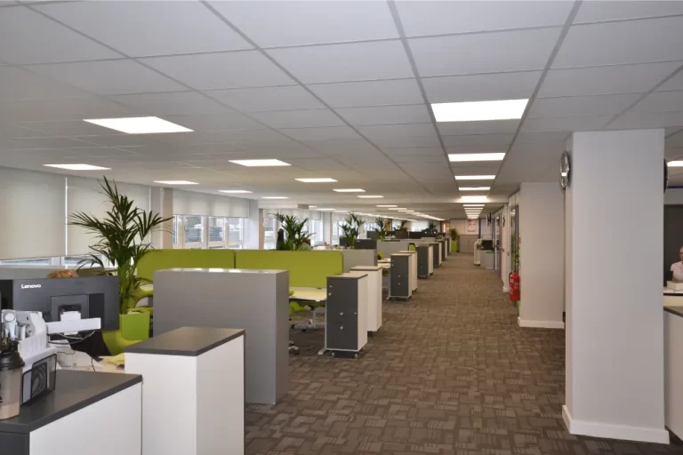 Hidden Hearing | Office space with desks and computer screens.