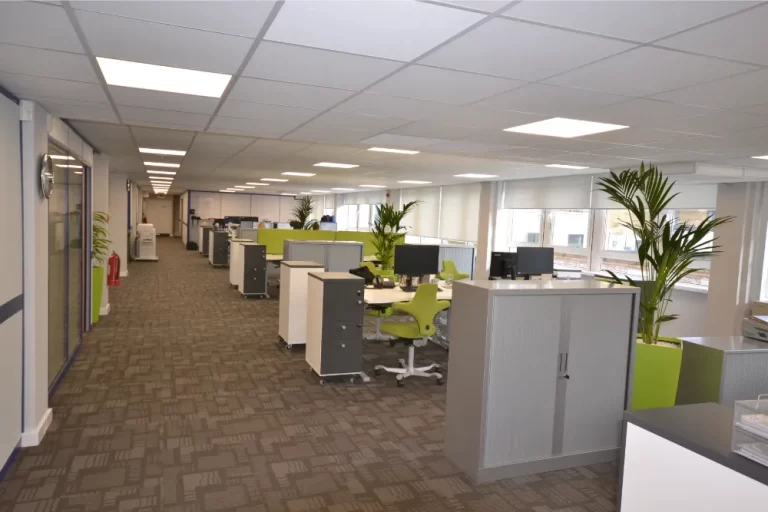 Hidden Hearing | Office space with desks and computer screens.