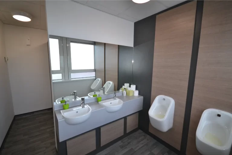 Hidden Hearing | Bathroom space with sinks and urinal