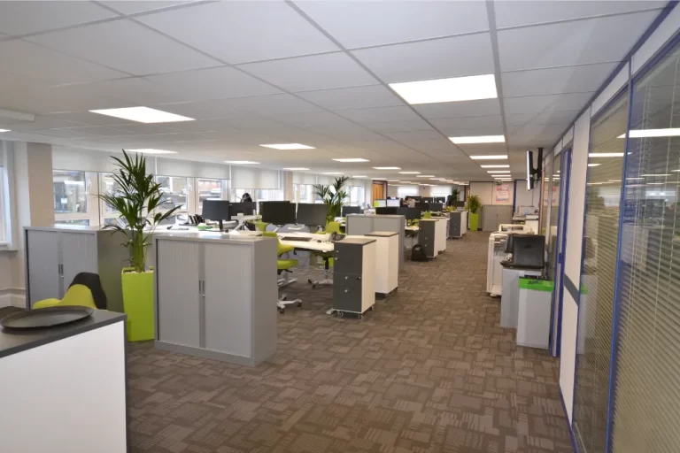 Hidden Hearing | Office space with desks and computer screens.