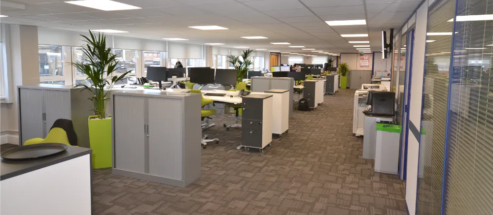 Hidden Hearing | Office space with desks and computer screens.