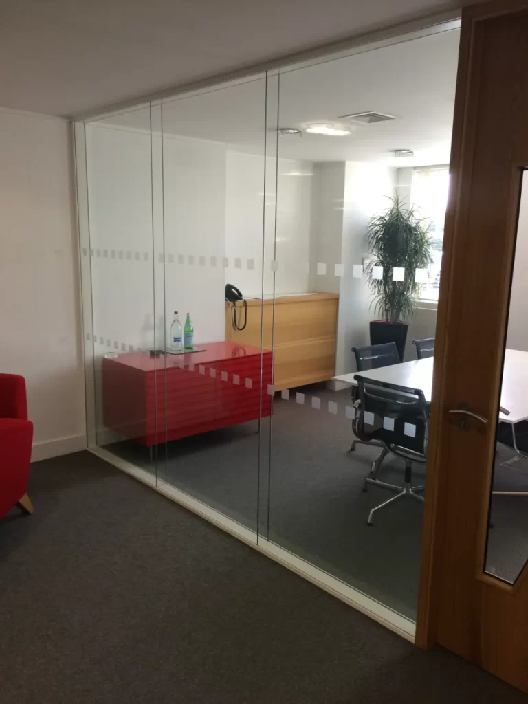 PDT Solicitors | Office space with glass partitions and wooden doors.
