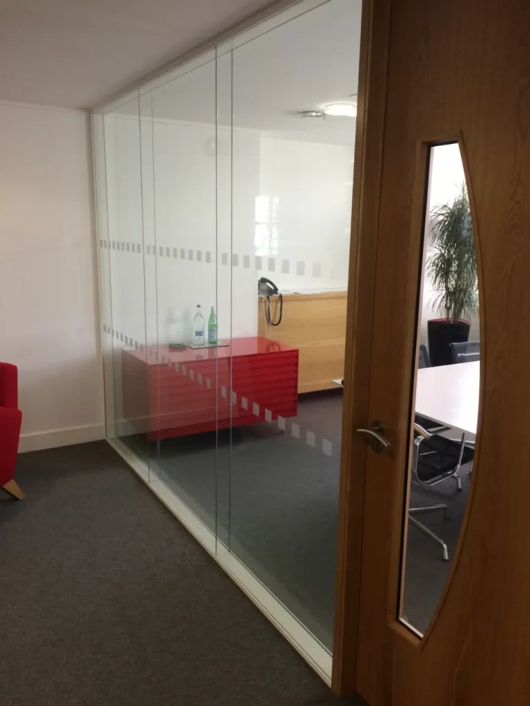 PDT Solicitors | Office space with glass partitions and wooden doors.