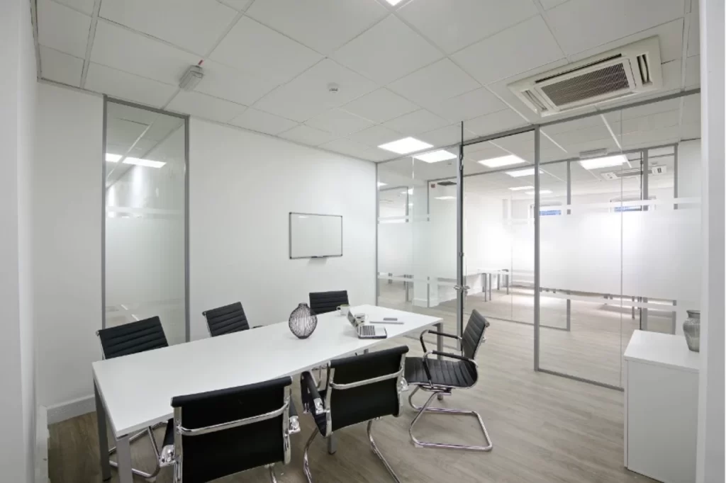 Modern boardroom with glass partitions.