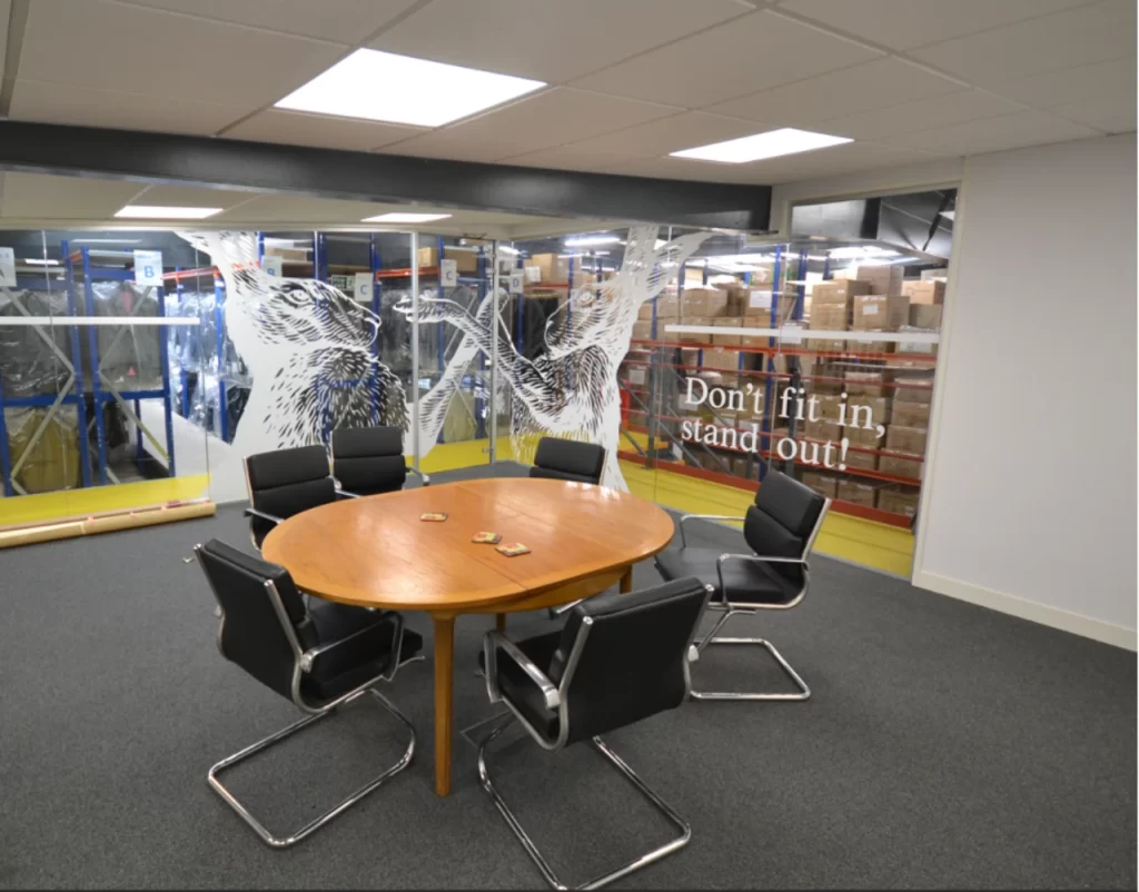 Modern boardroom with glass partitions.