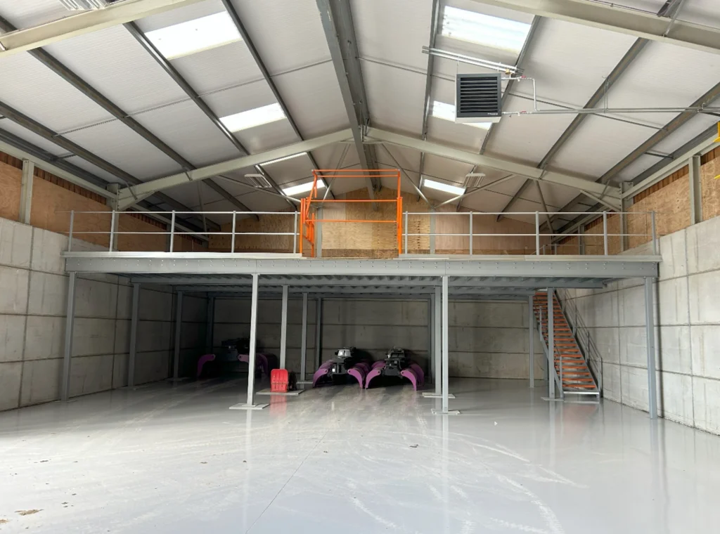 mezzanine floor installation | Mezzanine floor in a warehouse space with pallet gate.